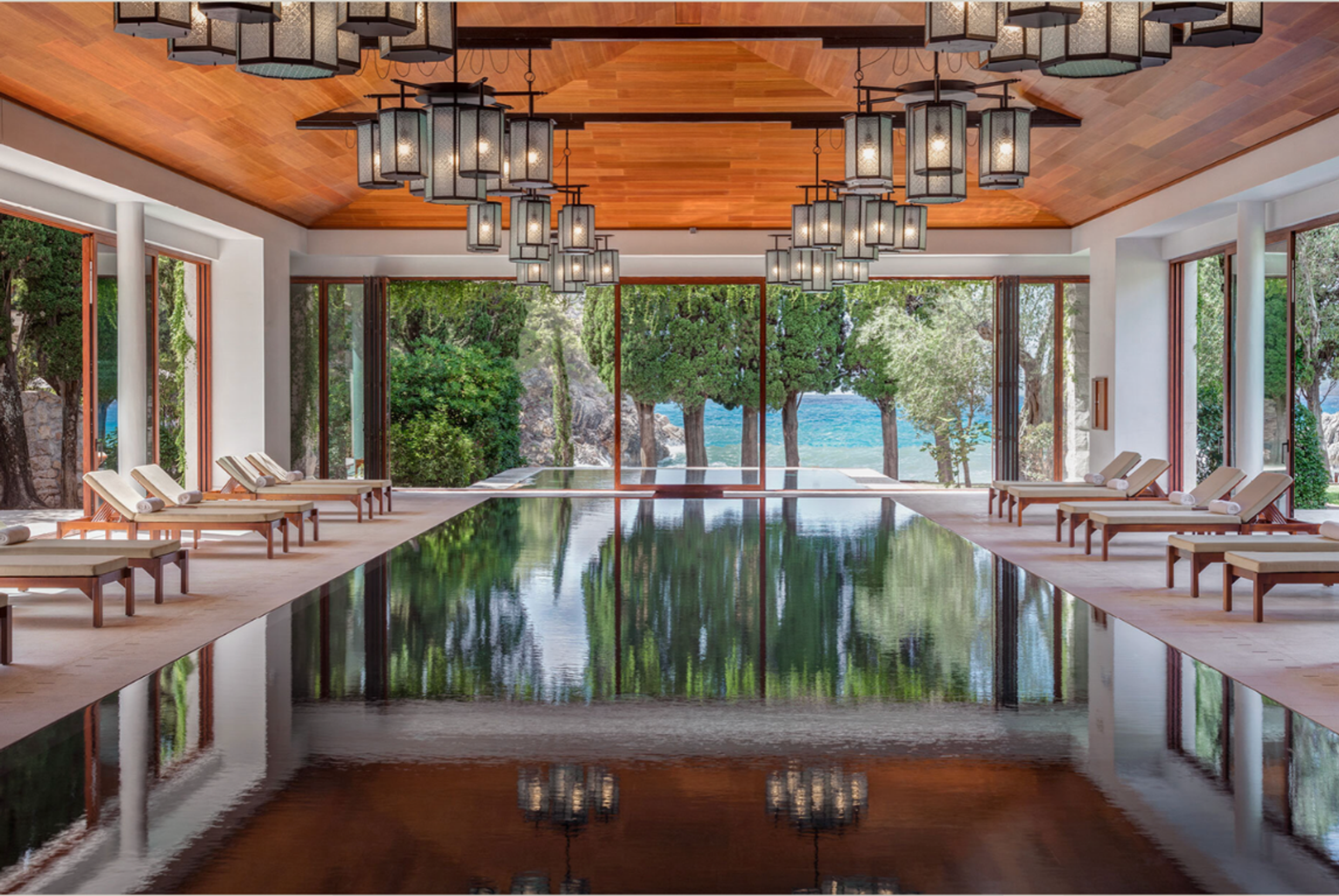image of reflective pool and loungers at the Aman luxury hotel in montenegro
