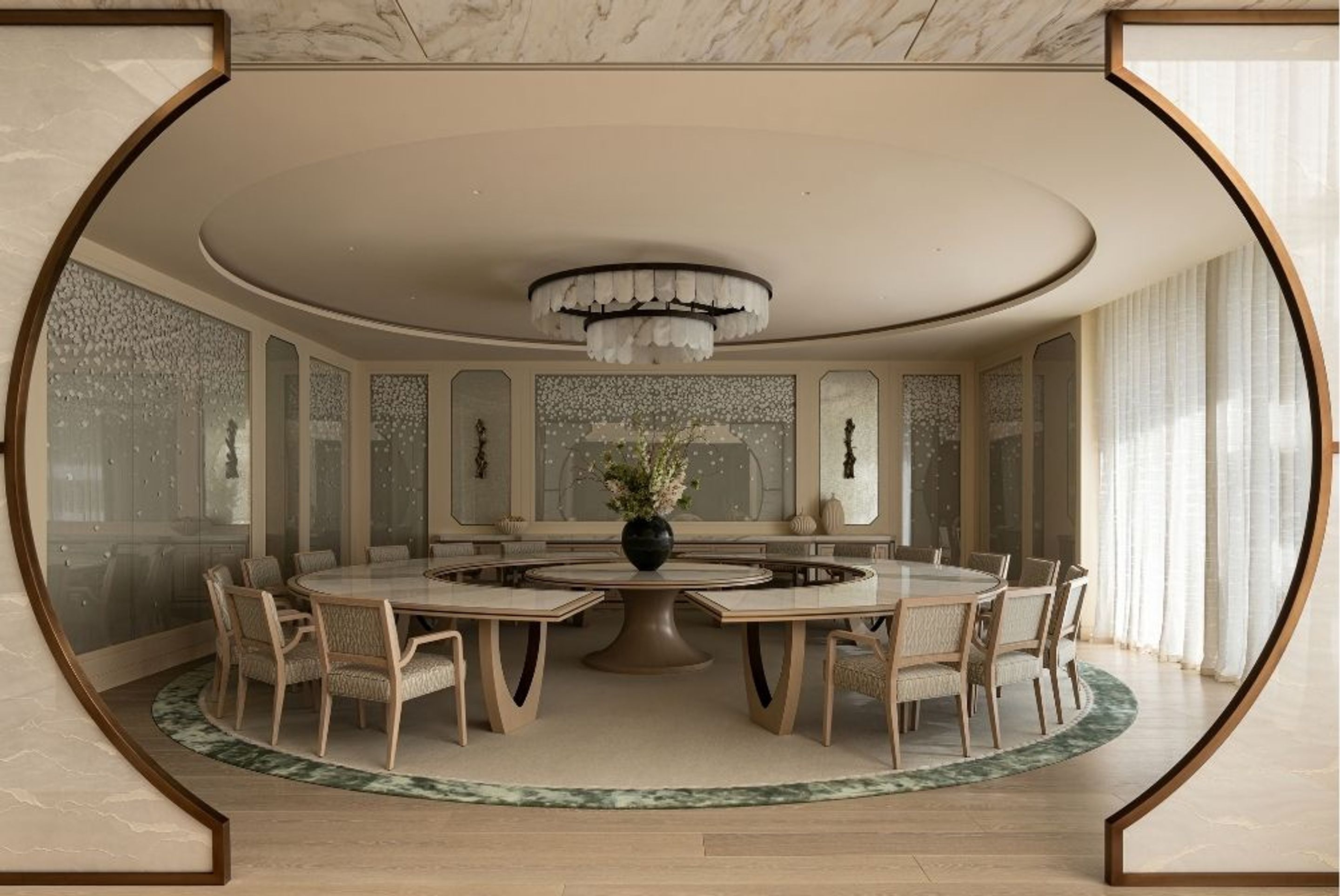Formal dining room with a bespoke circular dining table, upholstered chairs, decorative wall panels and an architectural arched entrance.