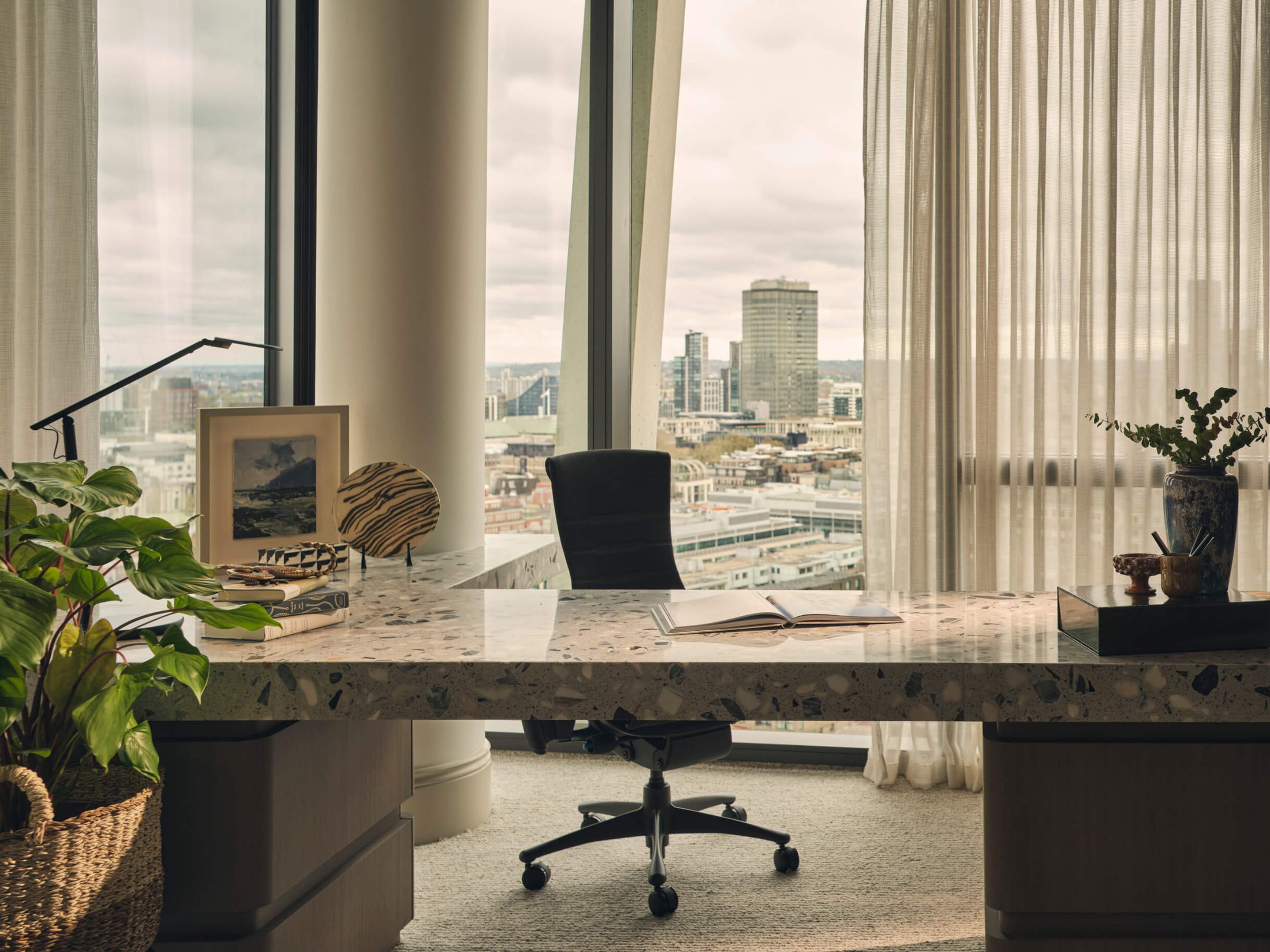 Desk with a city view behind it.