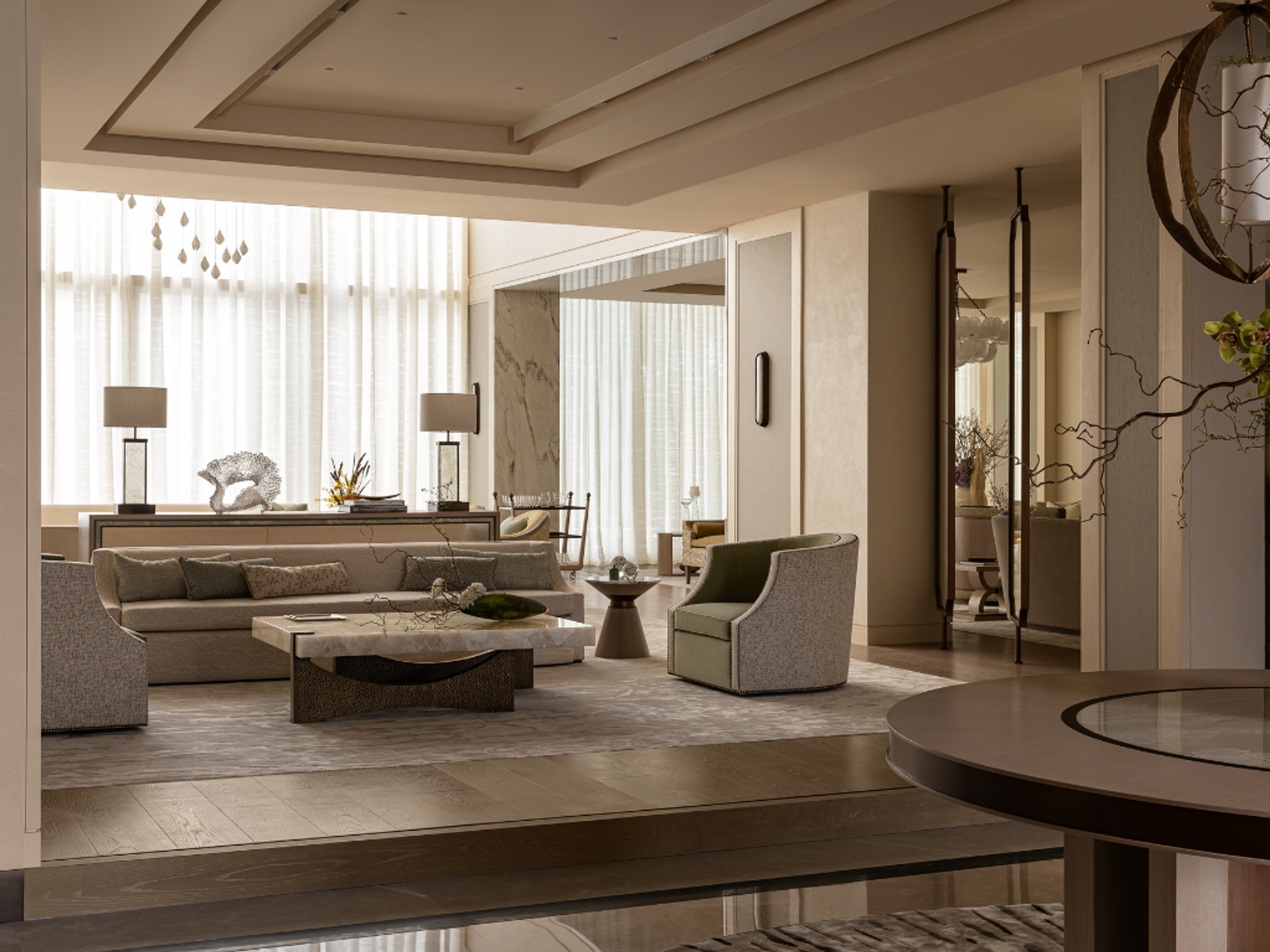 Formal majlis with layered seating, sculptural furniture, veined stone surfaces and soft daylight filtering through sheer curtains.