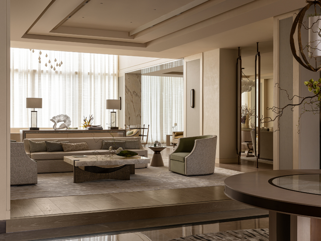 Formal majlis with layered seating, sculptural furniture, veined stone surfaces and soft daylight filtering through sheer curtains.