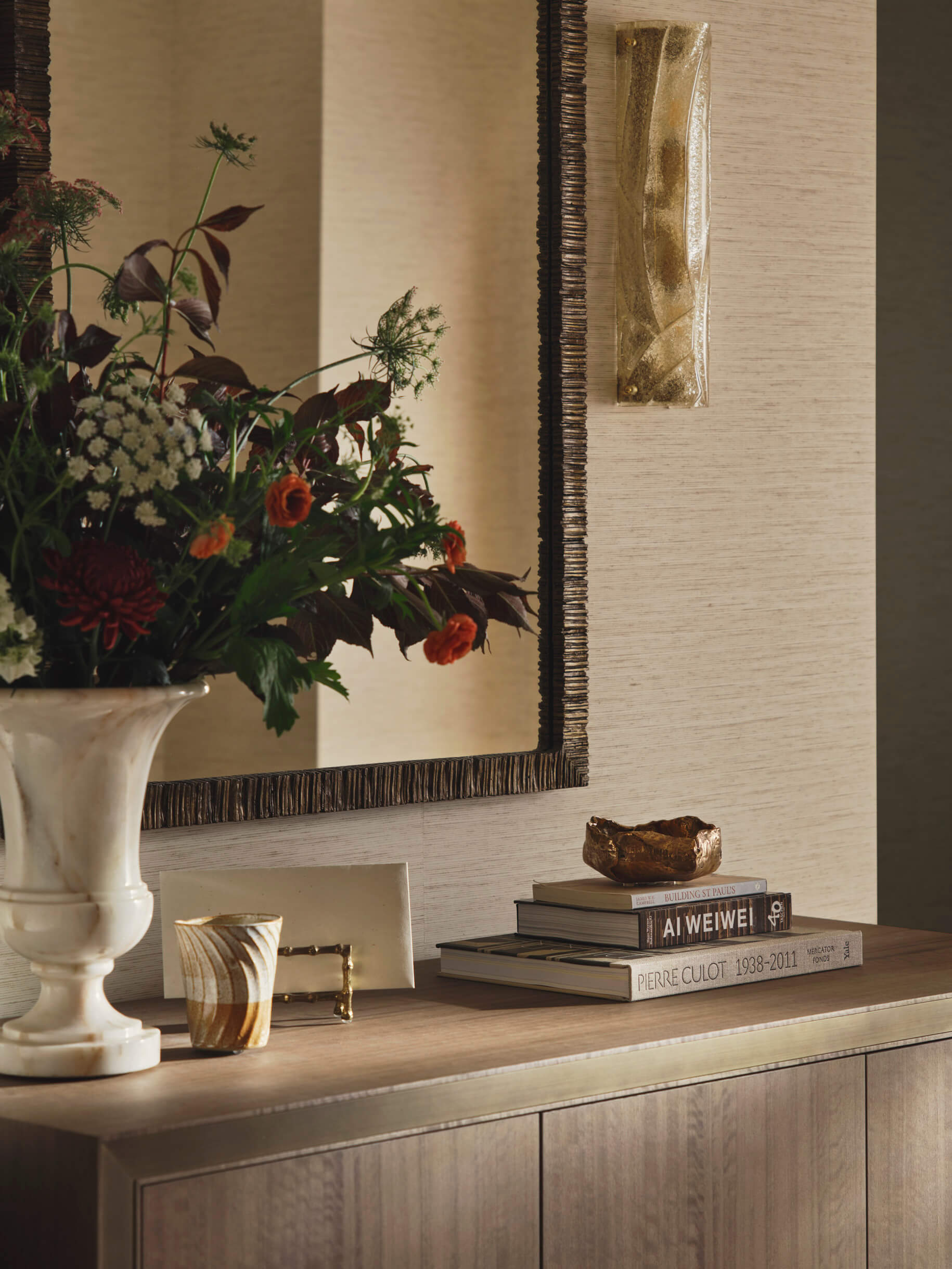 Console table with a vase and books