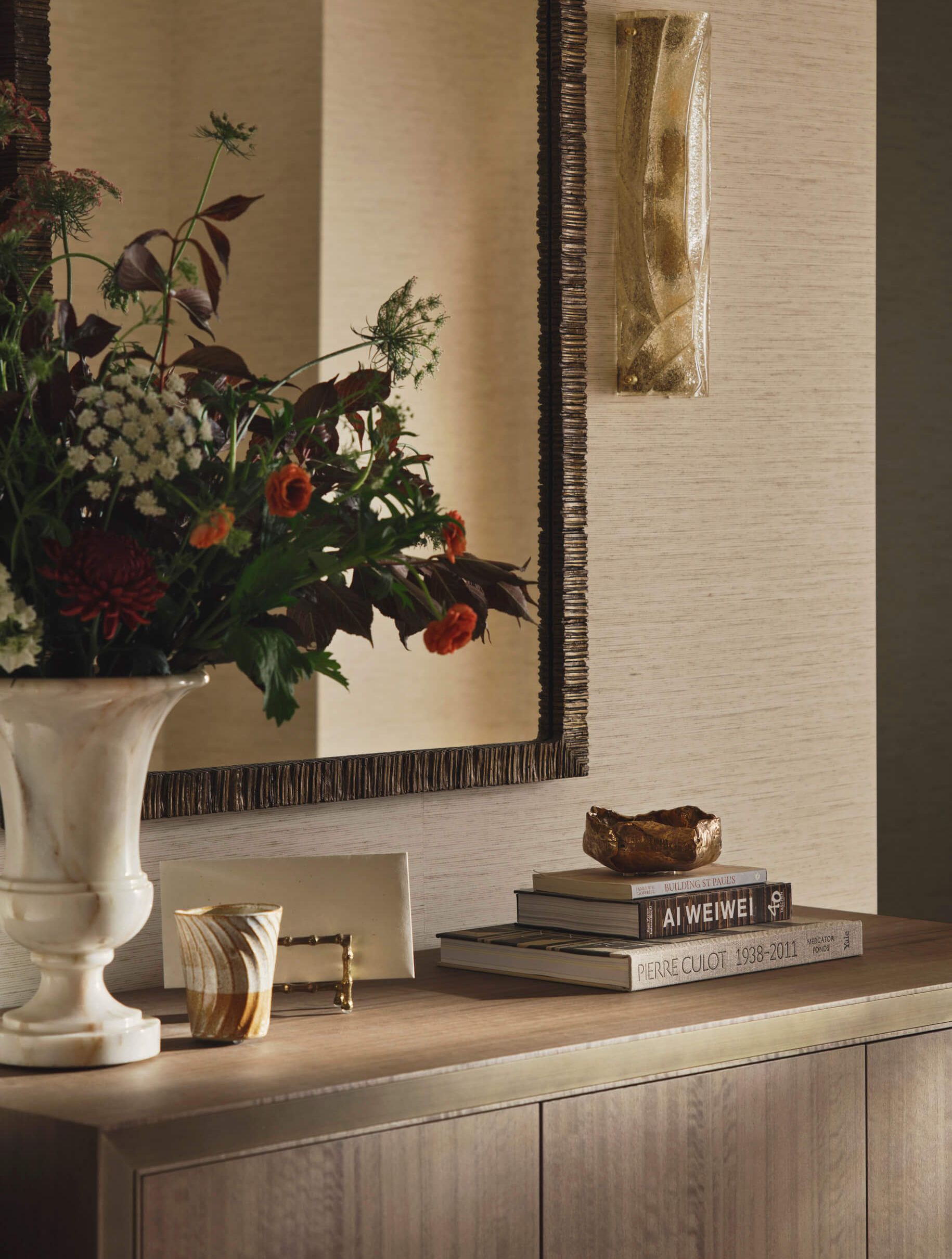 Console table with a vase and books