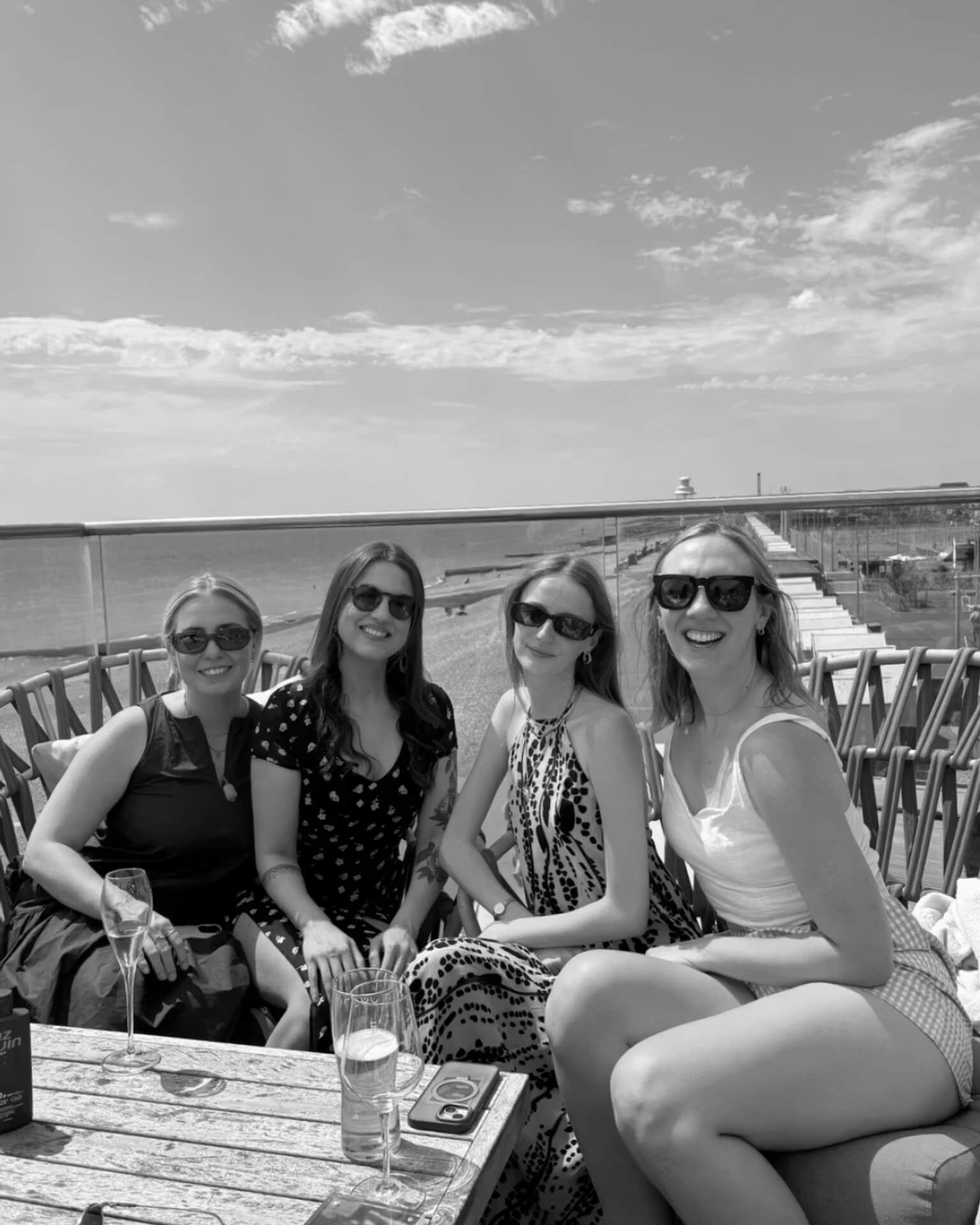 Four Elicyon Team members sitting at a bar at a team event.