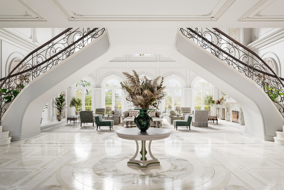 A grand double staircase in a light-filled entrance hall, defined by classical detailing, wrought iron balustrades and a central table with a sculptural floral arrangement.
