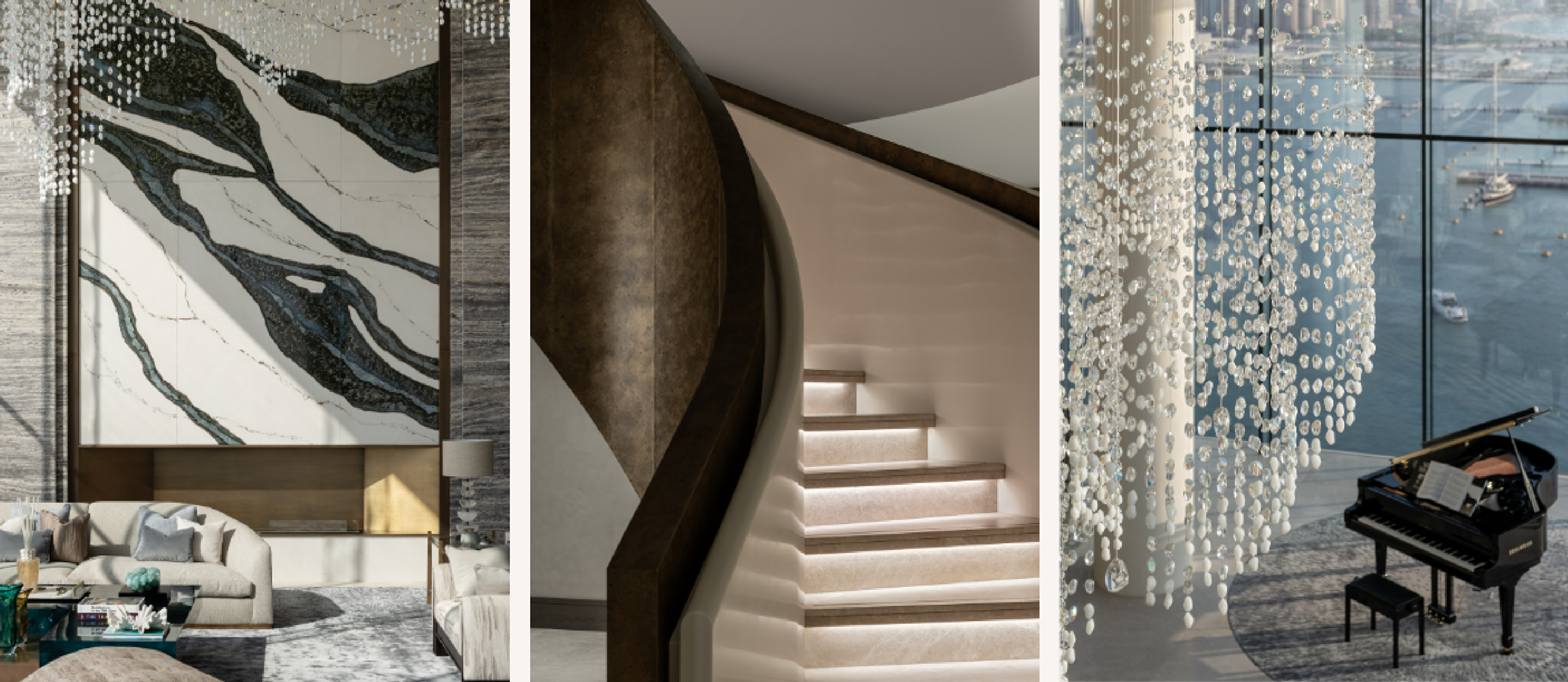 Dubai penthouse interior featuring a dramatic bookmatched stone feature wall, sculptural staircase and crystal chandelier overlooking waterfront views.