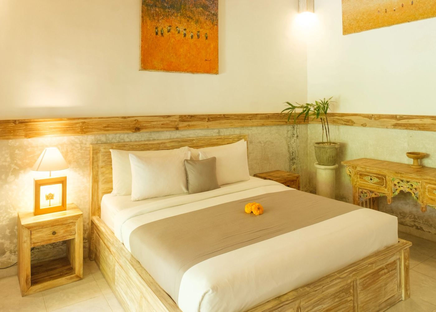 King bed with Balinese artwork above the headboard