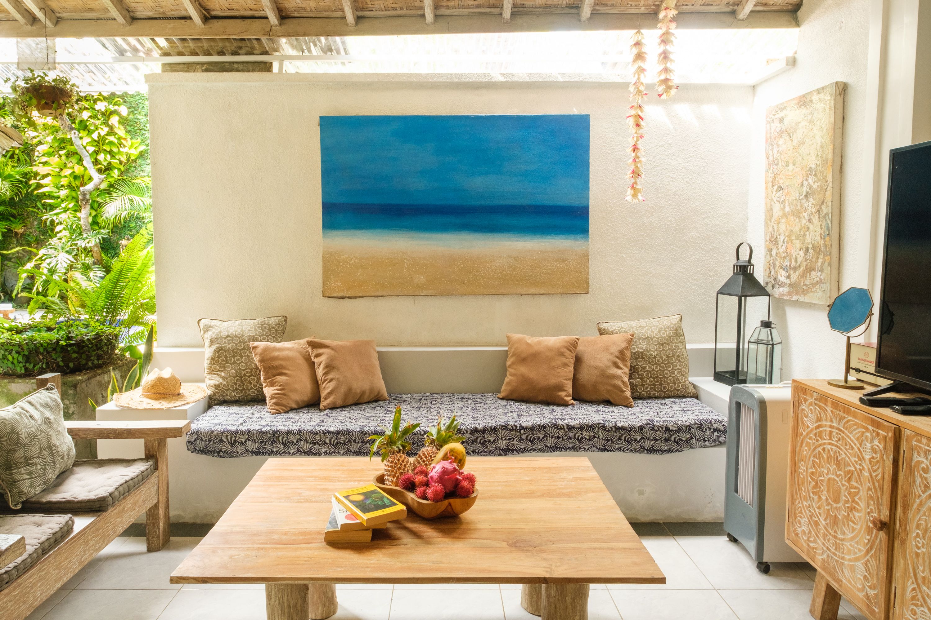 Living room with sofa, coffee table and ocean painting
