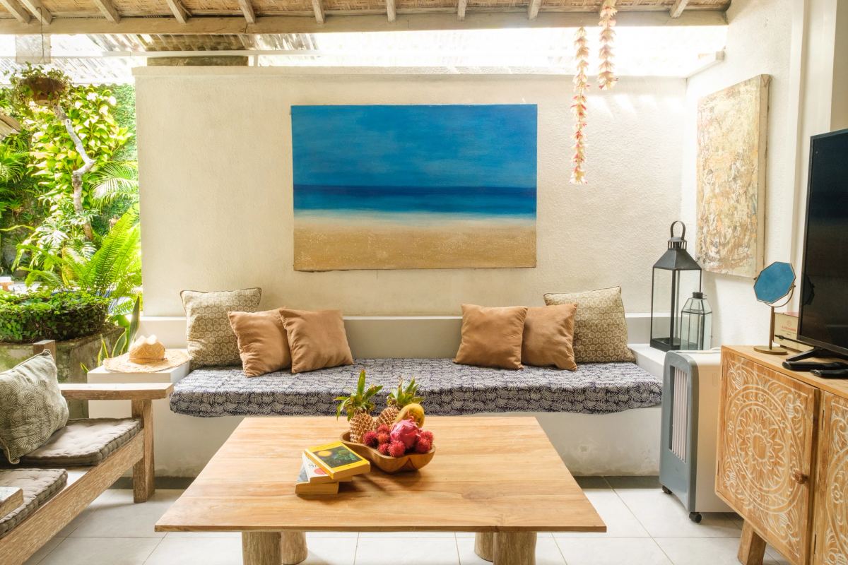 Living room with sofa, coffee table and ocean painting
