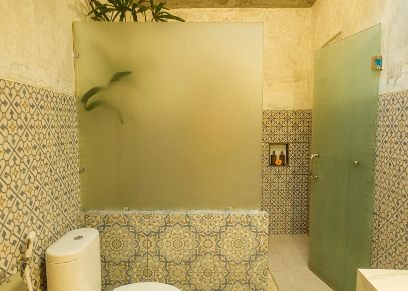 Shower area with frosted glass and stone floor