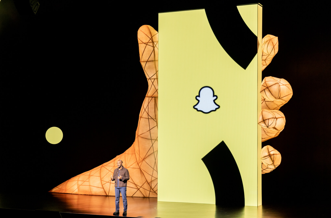 performer on stage in front of phone rendering