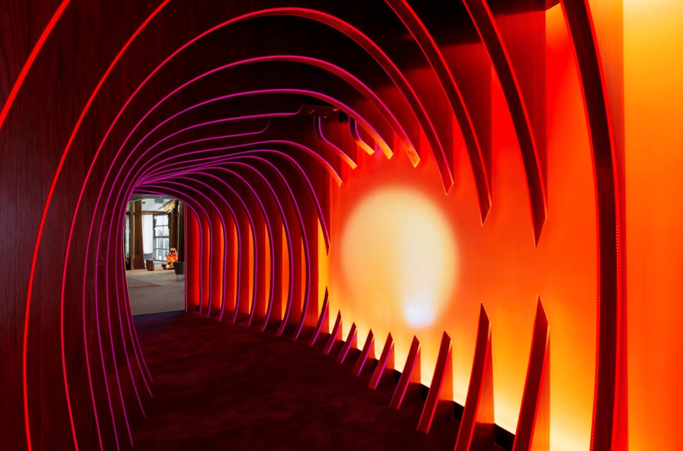 an orange art installation like hallway