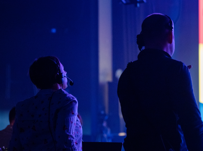 two people watching a stage