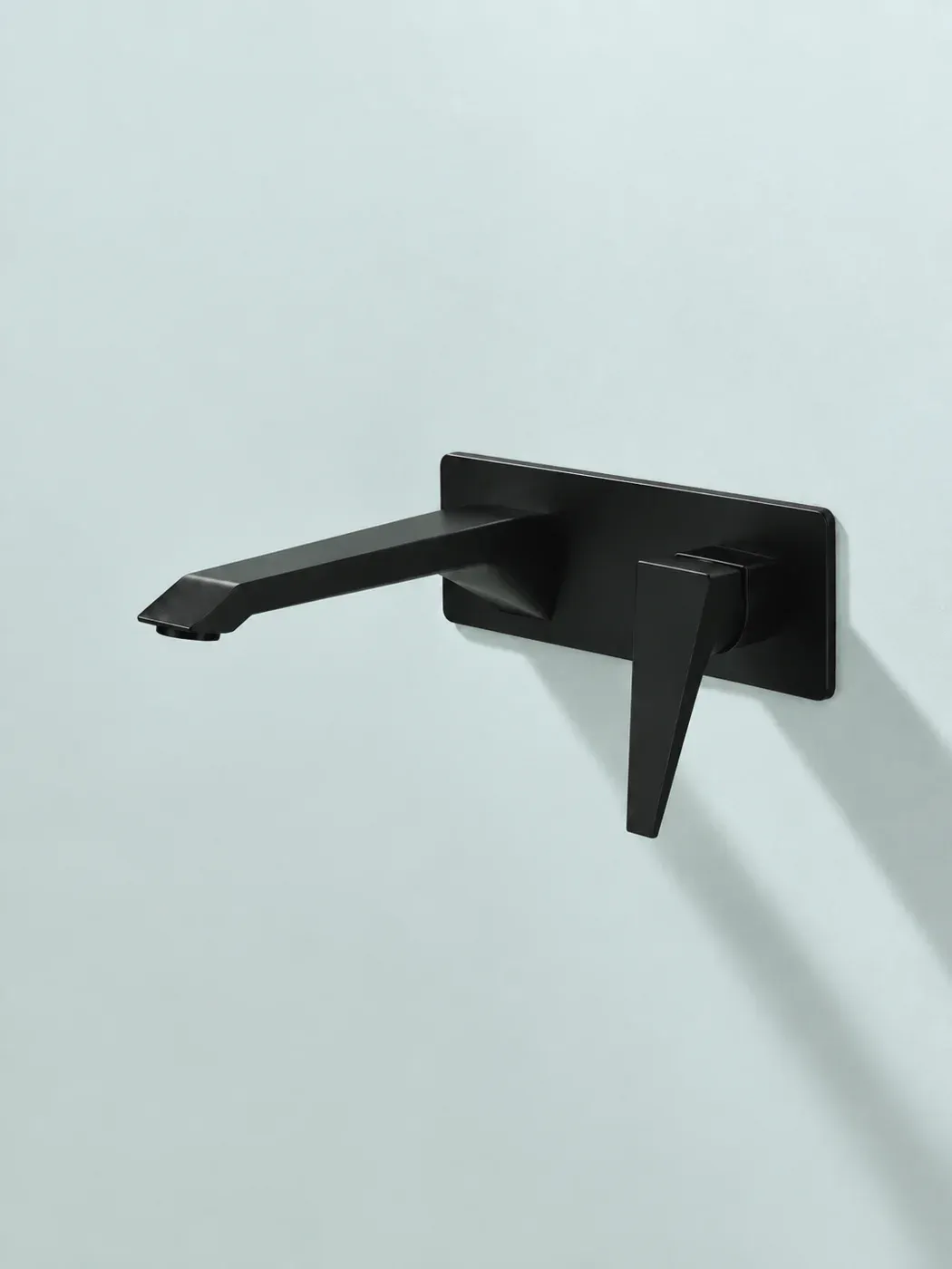 Matte black wall-mounted basin mixer with a long spout on a pale blue wall