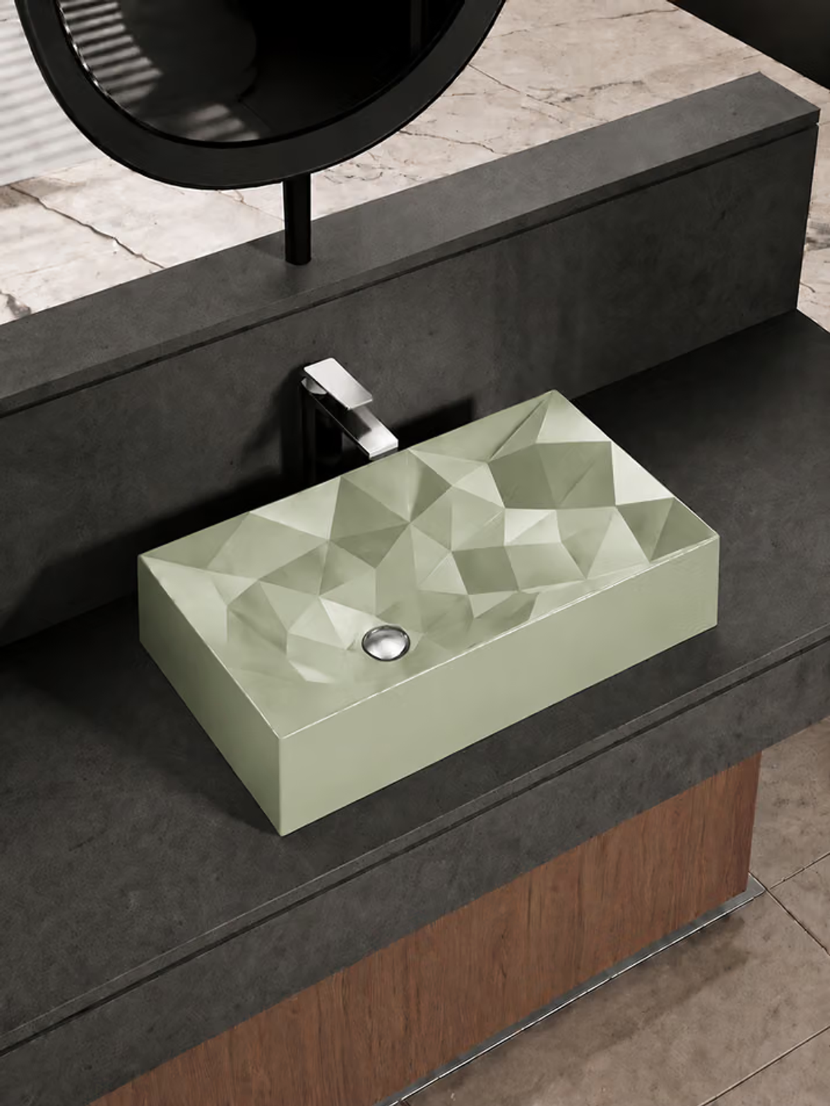 Pale green faceted rectangular countertop basin on a dark stone vanity with a chrome faucet