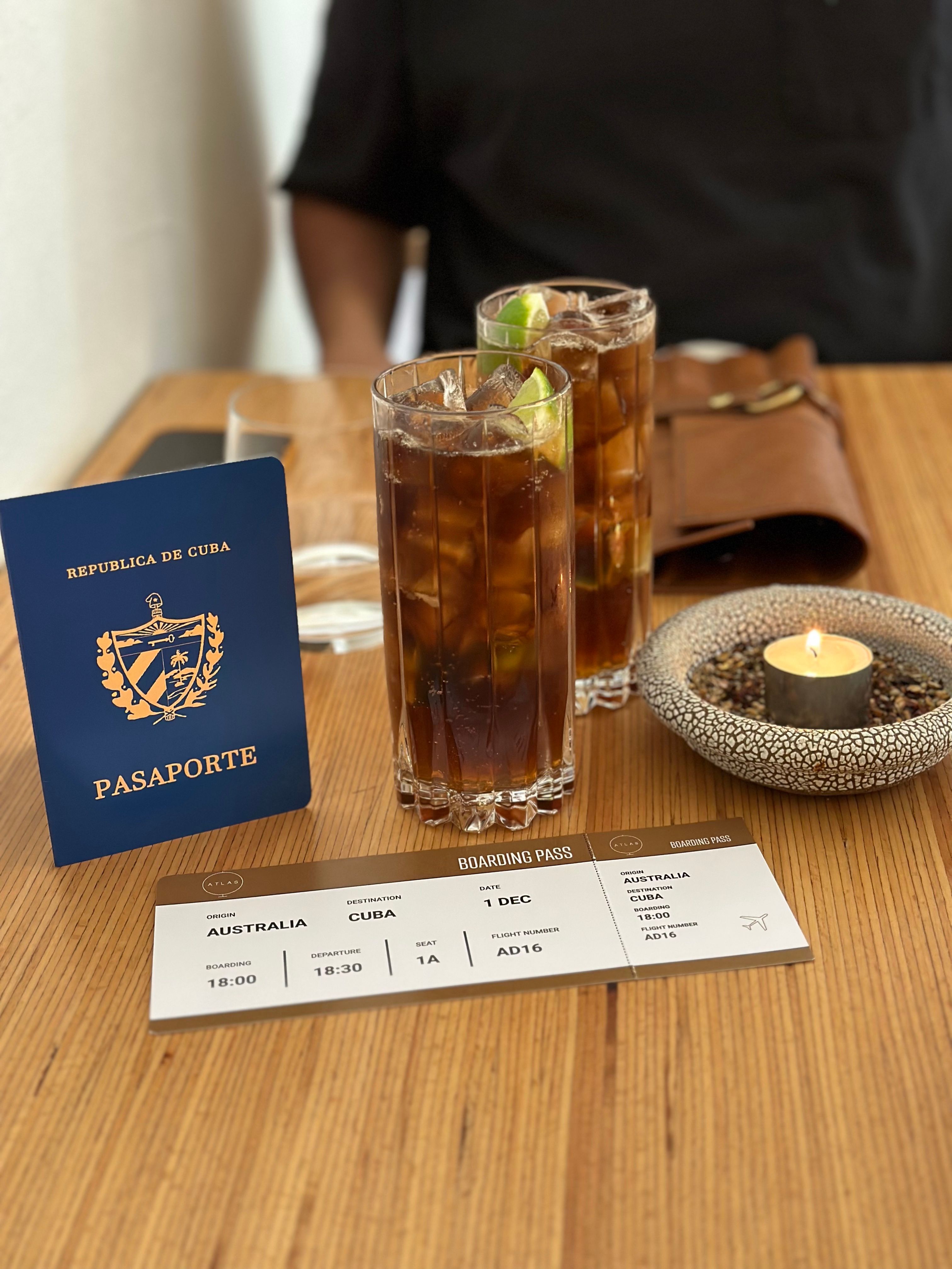 Two Cuba Libre with a passport and boarding pass prop