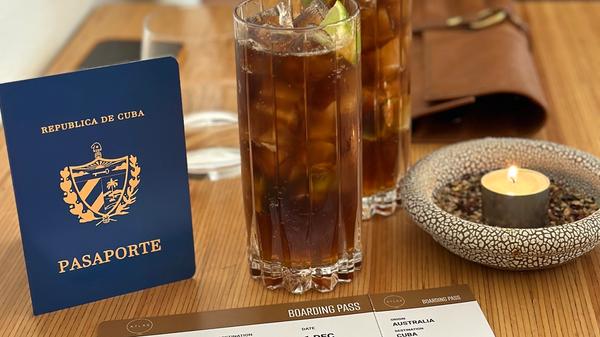 Two Cuba Libre with a passport and boarding pass prop