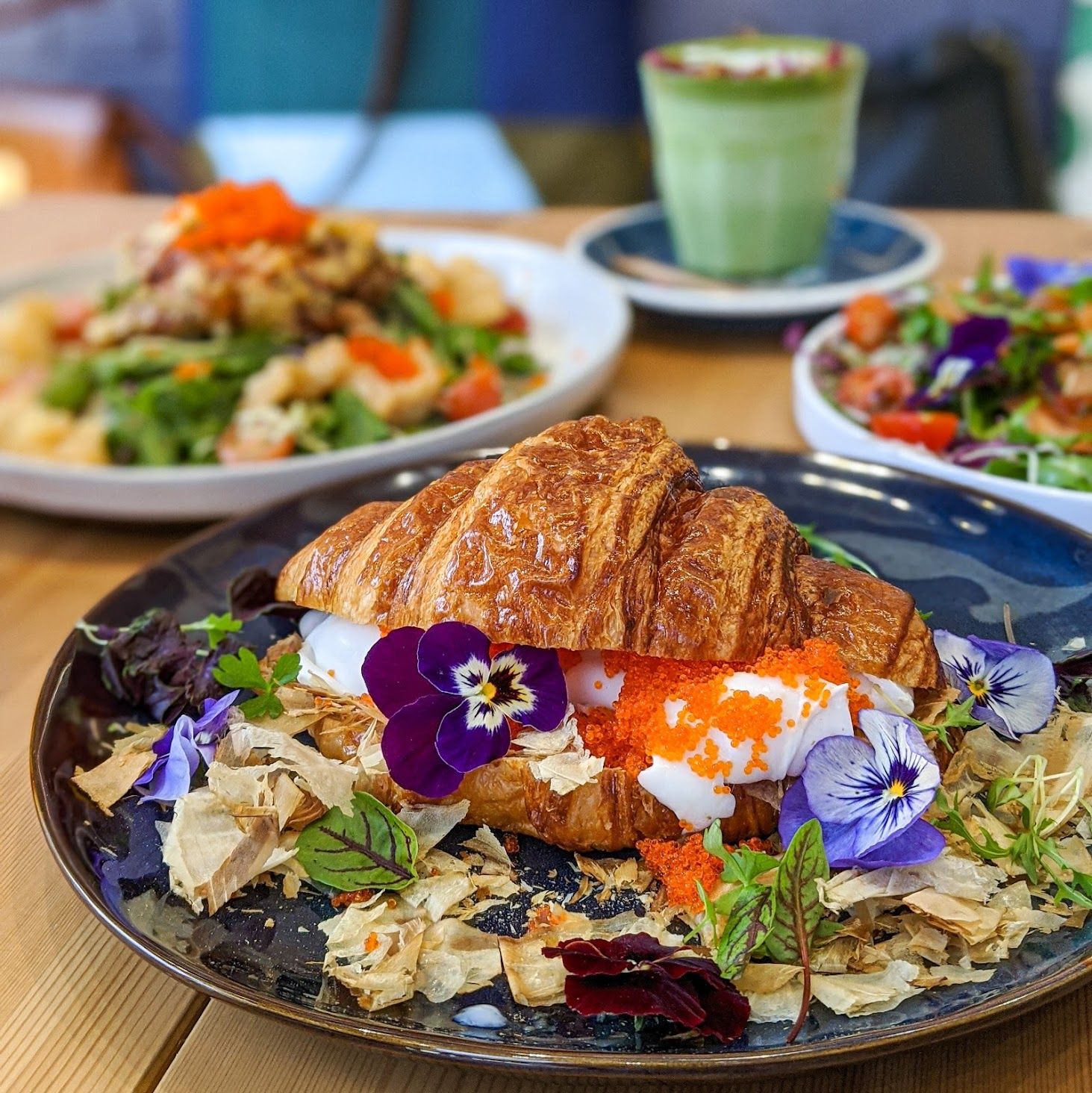 Croissant filled with egg, roe, flowers and bonito flakes