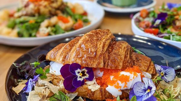 Croissant filled with egg, roe, flowers and bonito flakes