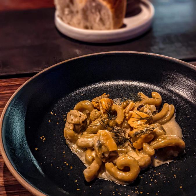 strozzapreti pasta with mussels, mustard greens & fennel pollen