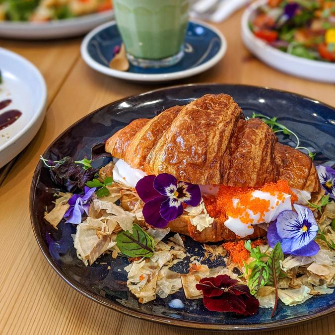 Croissant filled with egg, roe, flowers and bonito flakes