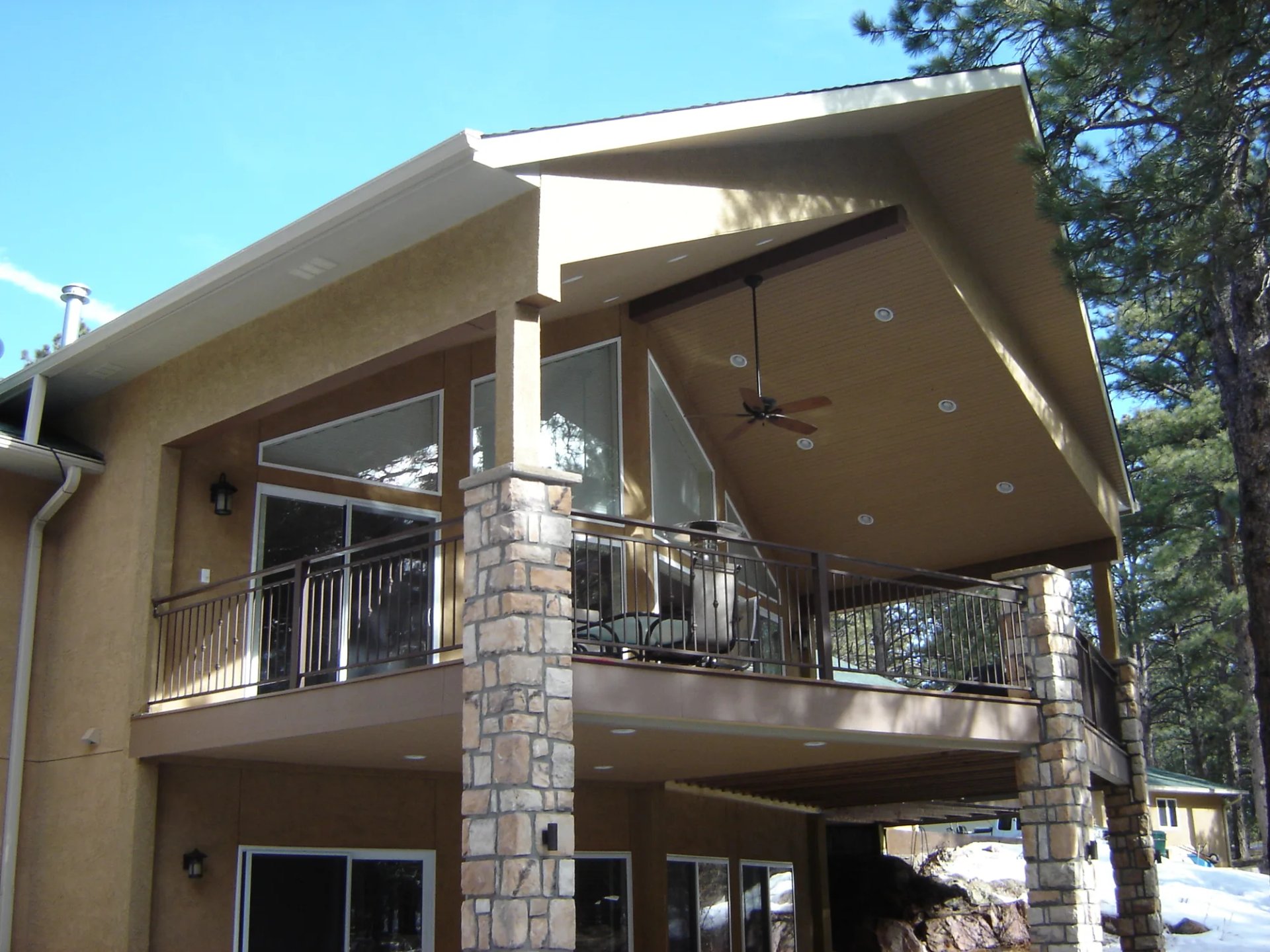 Covered deck with a patio cover by Stewart Remodel Design Build in Colorado Springs