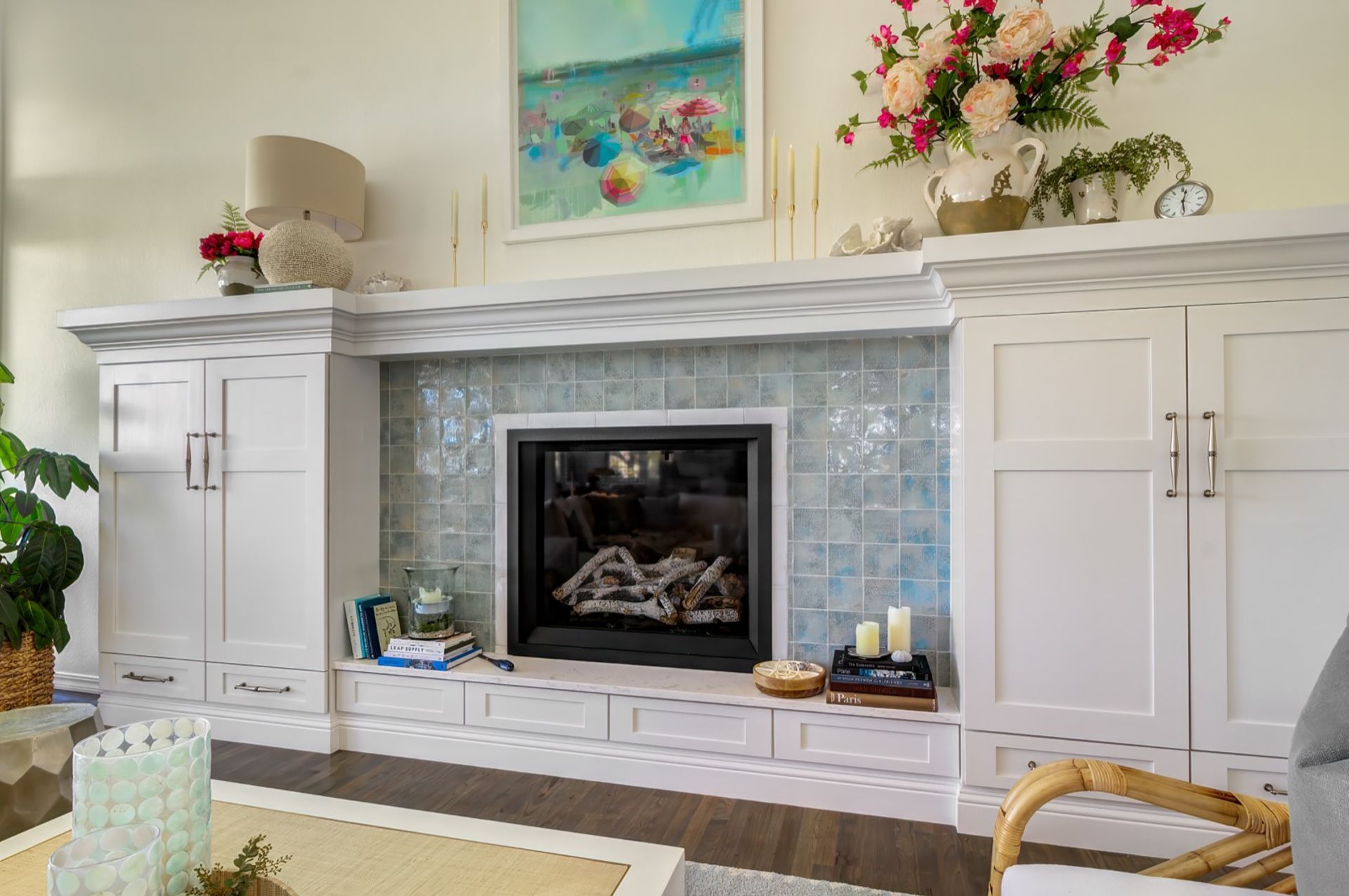 Modern glass fireplace with custom built-in shelving by Stewart Remodeling