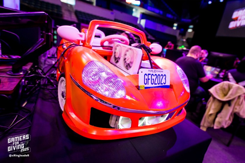 A PC in a race car shell, with a license plate that reads "GFG2023"