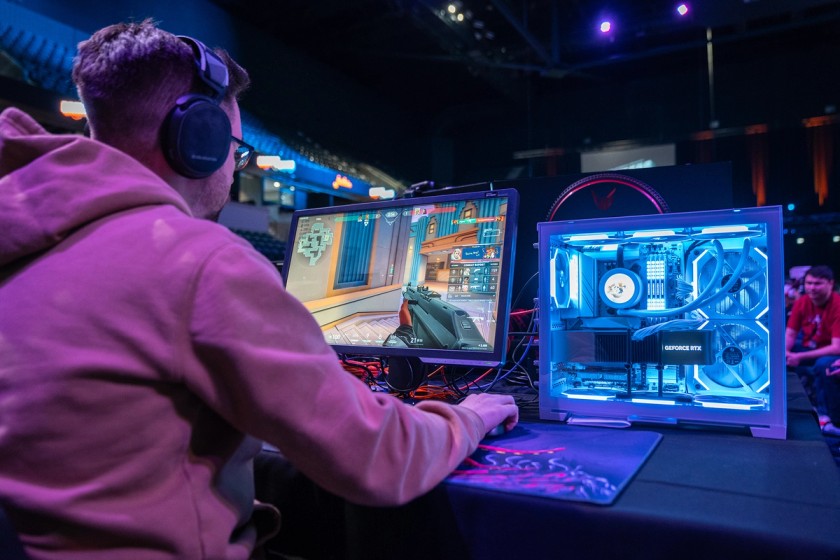 A LAN party participant enjoys gaming on his PC.