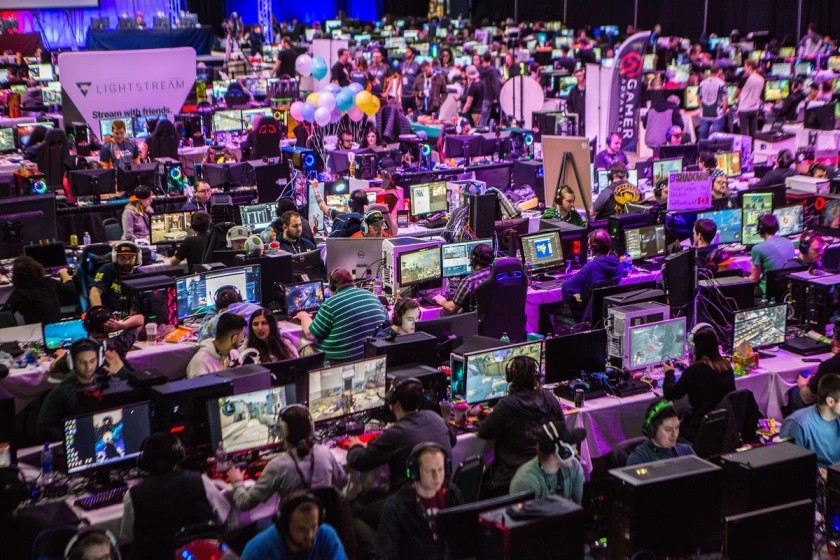 Photo of hundreds of LAN attendees playing on their gaming setups at a previous Gamers for Giving event.