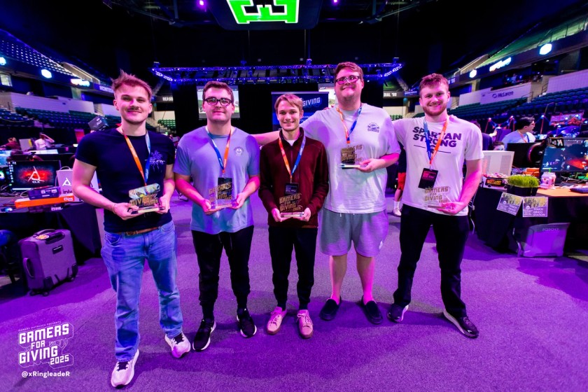Tournament winners at Gamers For Giving posing with trophies