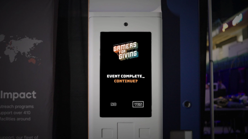 Save Point machine display with the Gamers for Giving logo and text reading "Event Complete_ Continue?". No and Yes options are displayed beneath this text with Yes highlighted.