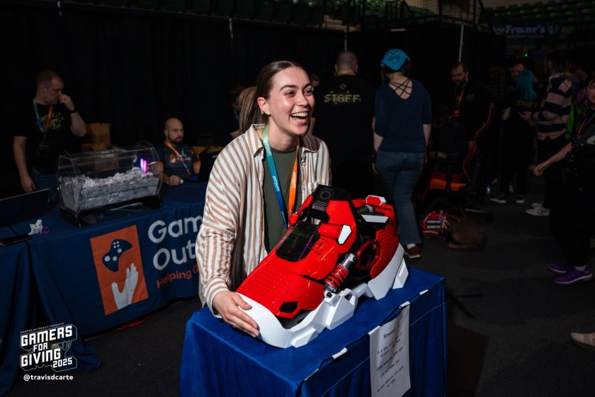 A GFG attendee posing with the sneaker PC prize