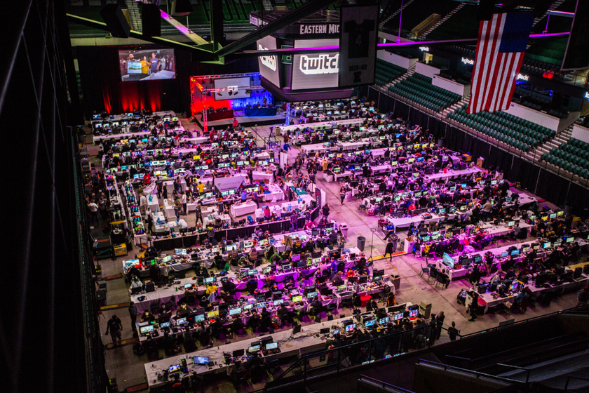 Overview of Gamers for Giving LAN arena with rows of PC setups.