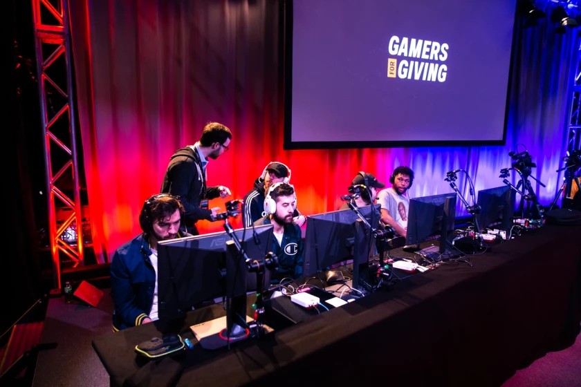Players on stage competing in a Gamers for Giving headline tournament.