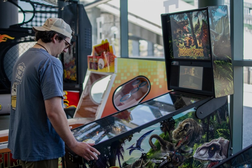 Attendee enjoying pinball at the GFG arcade