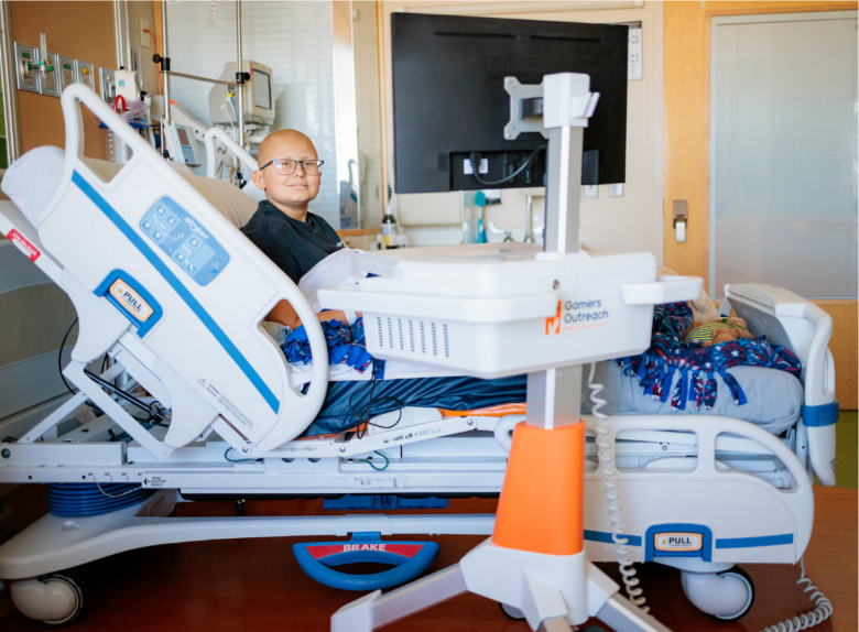 A hospitalized child playing on a GO Kart