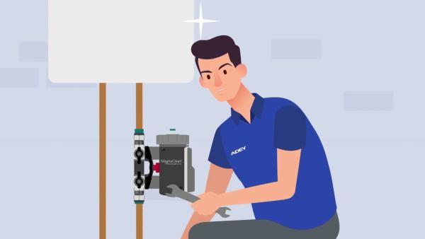 Illustration of an engineer fitting an ADEY MagnaClean magnetic system filter under a boiler.