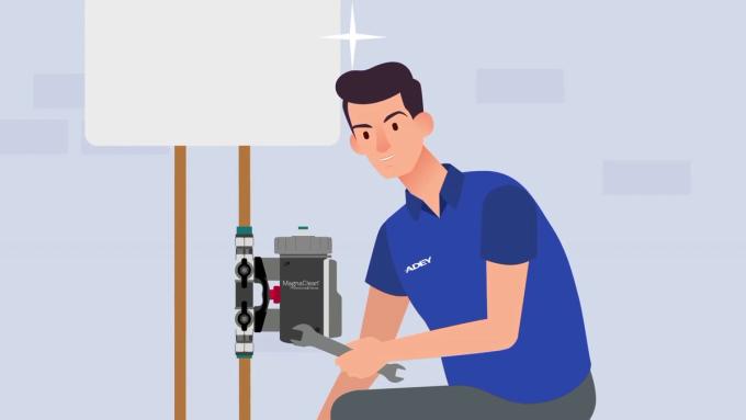 Illustration of an engineer fitting an ADEY MagnaClean magnetic system filter under a boiler.