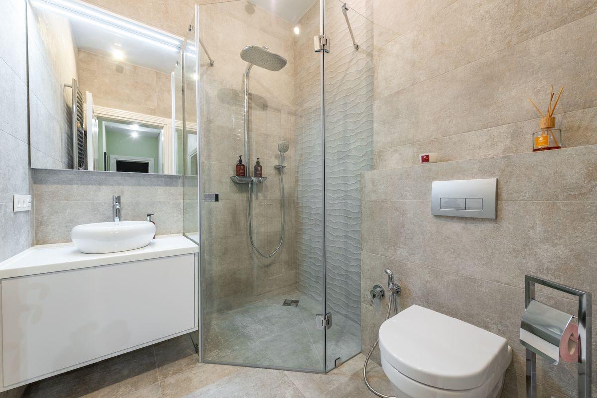 A compact modern shower room with a glass shower enclosure, basin and wall-hung toilet.