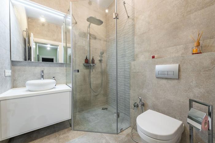 A compact modern shower room with a glass shower enclosure, basin and wall-hung toilet.