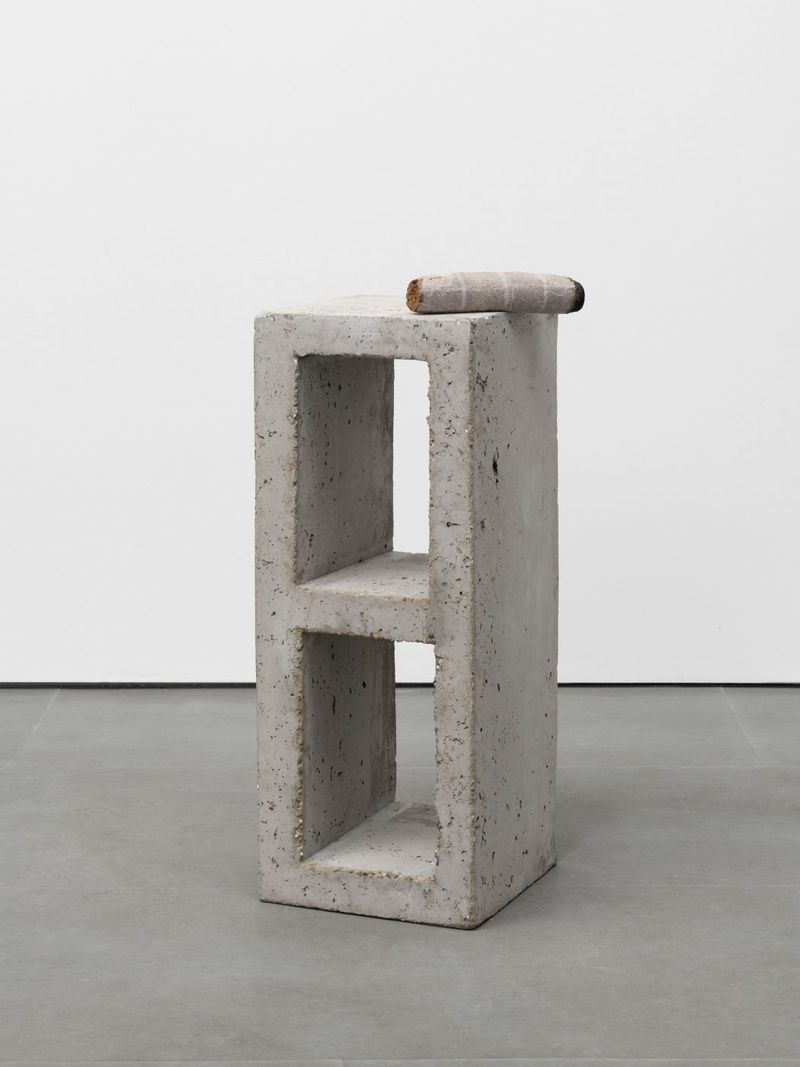 Installation view of displayed artwork titled Parpaing (concrete block and tabacco)