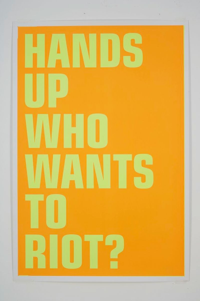 Installation view of displayed artwork titled HANDS UP WHO WANTS TO RIOT?
