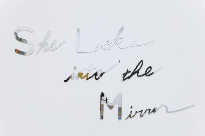 Installation view of displayed artwork titled She Looks Into The Mirror