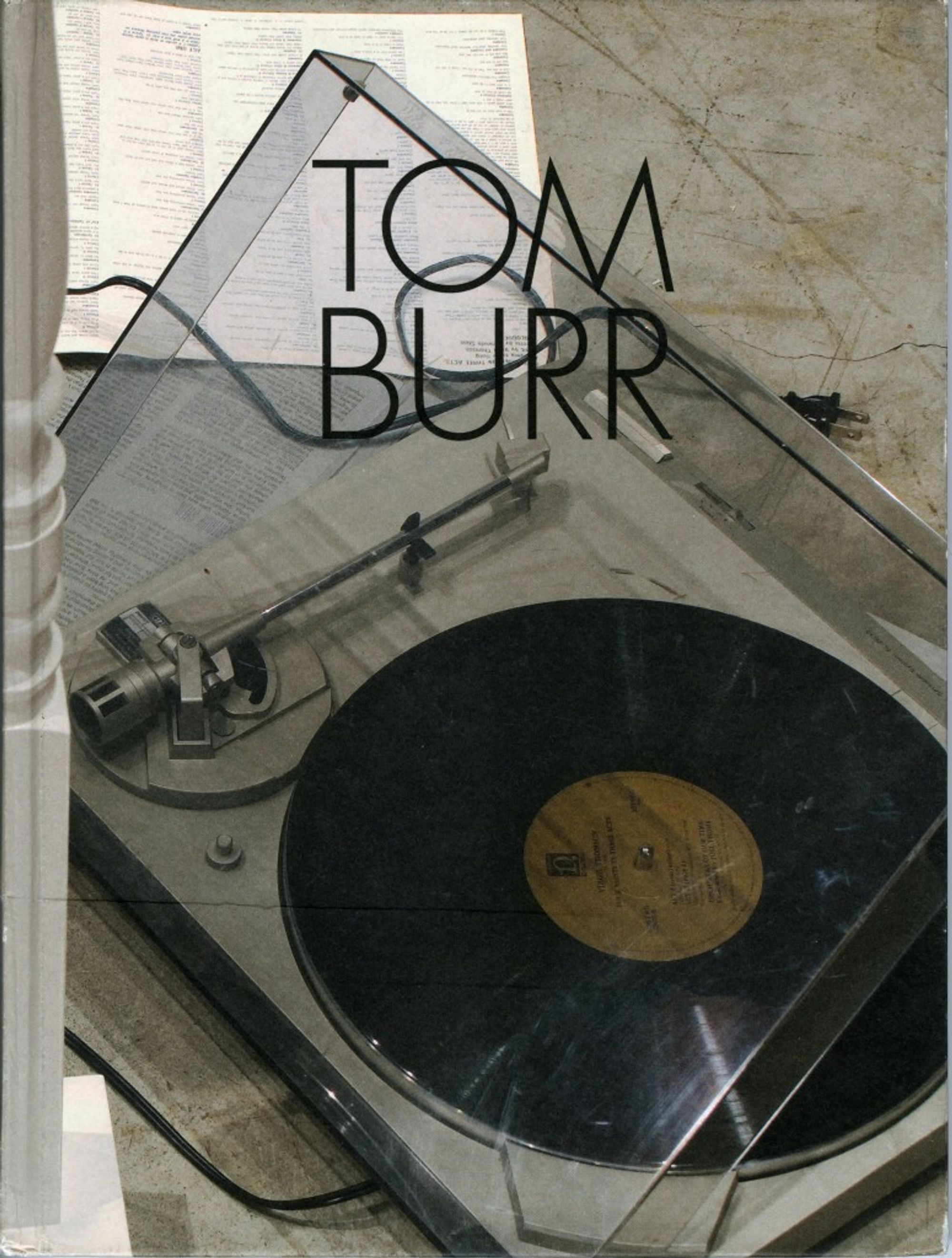 Detail view of Tom Burr against a plain gray background