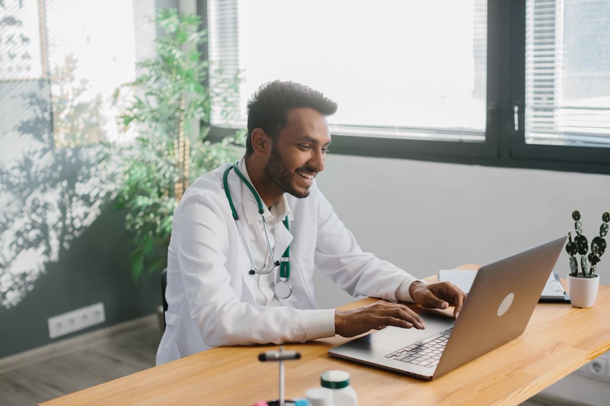 Young Indian doctor speaking to patient on a video call