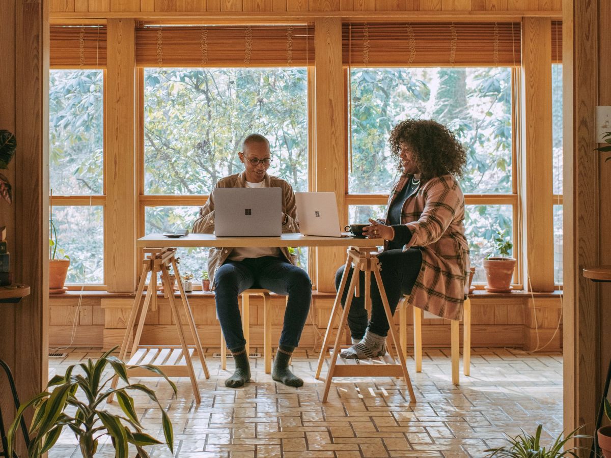 Two doctors working from home on laptops, helping patients via telemedicine