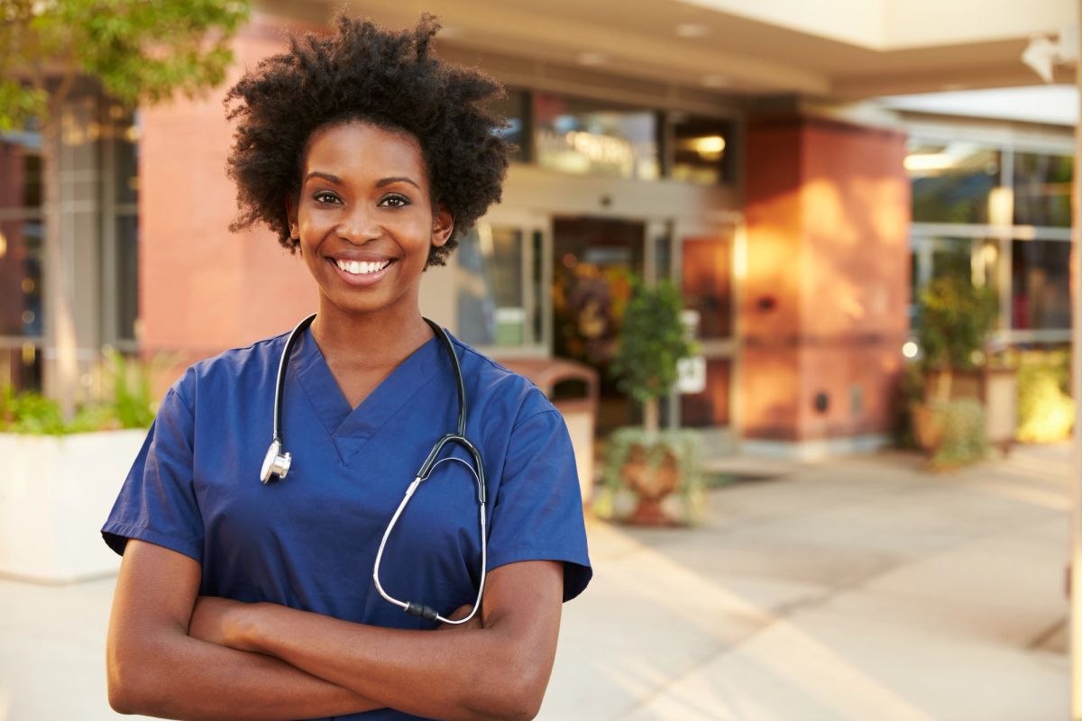 Physician standing outside of an emergency room entrance