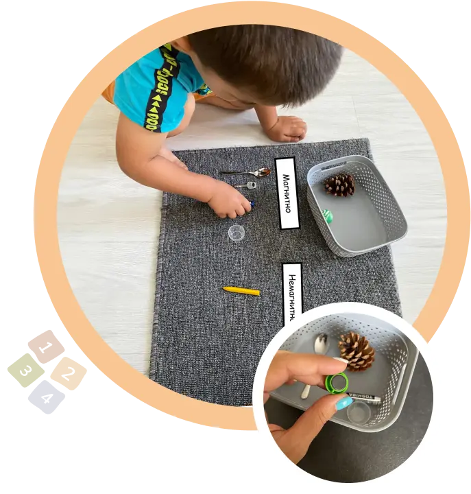 Дете играе на пода с магнитни и немагнитни предмети