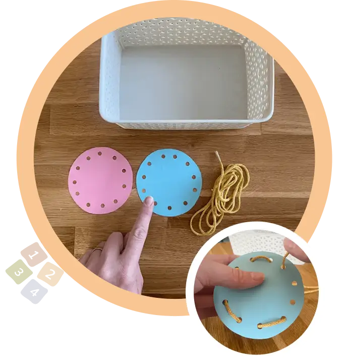 бял панер поставен до розов и син кръг с дупки и връвчица